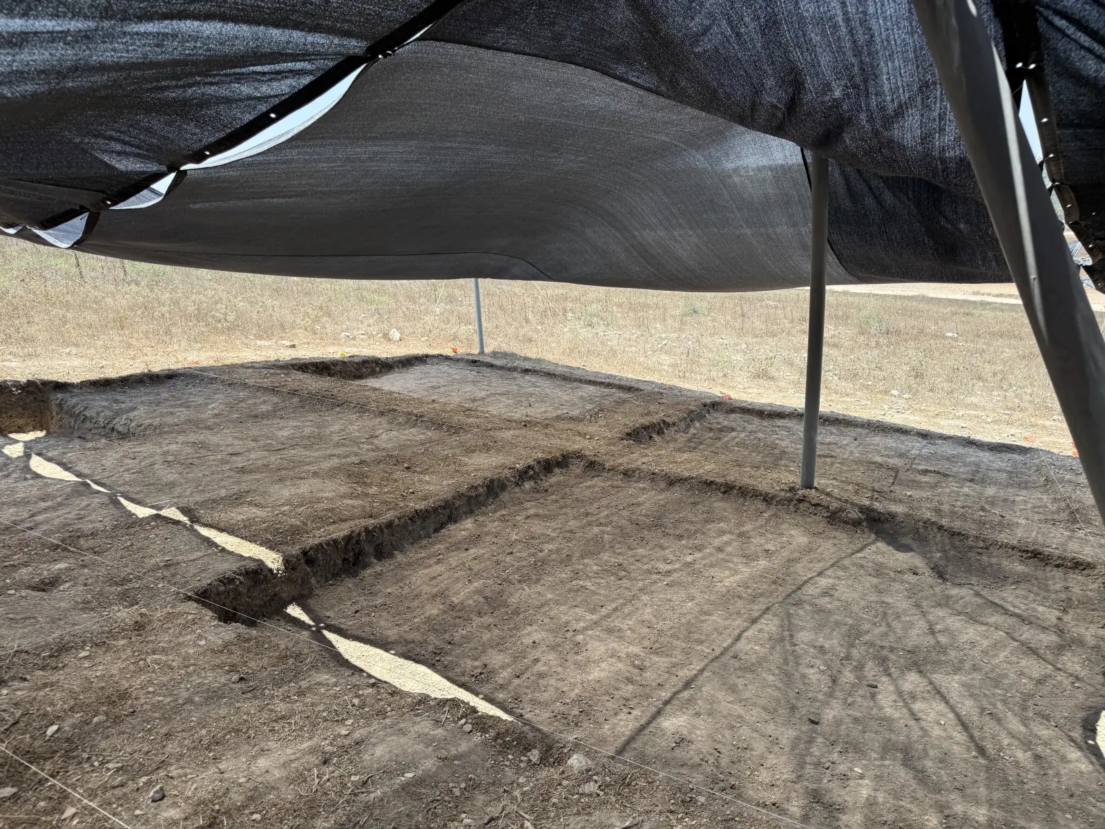 Tel Hanaton: Excavation squares under shade, separated by standing baulks.
